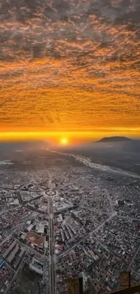 This phone live wallpaper offers a breathtaking aerial view of a city atop a mountain