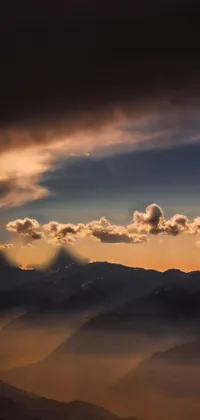 This phone live wallpaper captures a breathtaking mountain view from a hilltop
