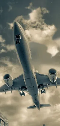 This live wallpaper depicts a large jetliner flying among fluffy clouds