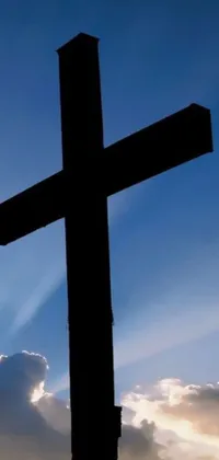 This phone live wallpaper offers a stunning image of a black cross set against a bright blue sky
