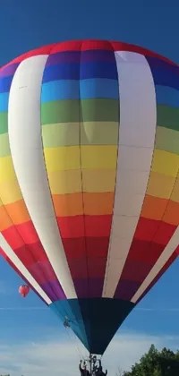 Get this stunning phone live wallpaper of a colorful hot air balloon flying through a blue sky by Okuda Gensō's style of color field