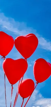 Get this beautiful live phone wallpaper featuring a mesmerizing sky blue background image adorned with a bundle of vibrant red heart-shaped balloons soaring in the air