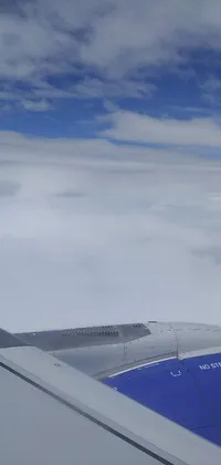 This live wallpaper offers a captivating view of an airplane's wing soaring through the sky