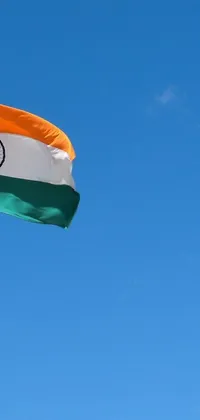 This live wallpaper displays the Indian flag flying high in the blue sky
