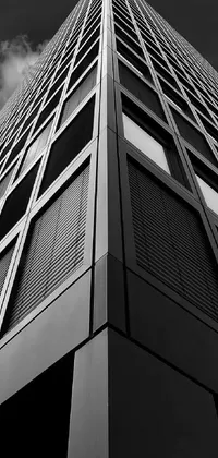 This phone live wallpaper features a high-quality black and white photograph of a tall building