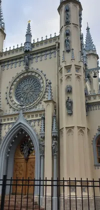 This live phone wallpaper portrays a gothic baroque-style church with an ornate clock and spikes