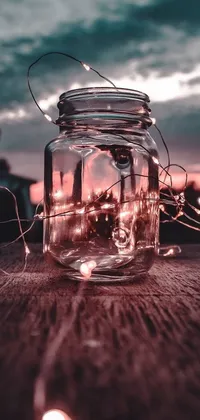 This phone live wallpaper showcases an eye-catching jar filled with sparkling fairy lights resting atop a wooden table