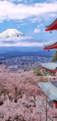 This 4K live phone wallpaper depicts a stunning traditional Japanese scene, complete with a beautiful pagoda against a picturesque mountain backdrop
