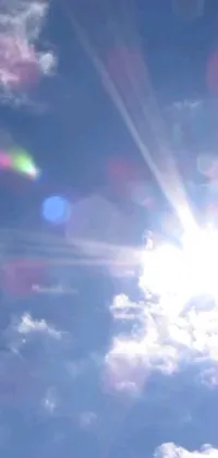 Brighten up your phone’s screen with this stunning live wallpaper featuring a cheerful sun glowing through the clouds