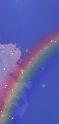 This phone live wallpaper showcases a vibrant rainbow in the sky created using a pointillism painting technique
