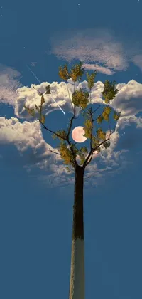 This phone live wallpaper showcases a magical and surreal landscape with a tree, moon, and flying park items