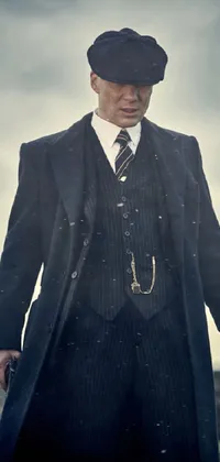 Suit up your phone with this elegant live wallpaper featuring a full body shot of a man in formal wear standing in a grassy field on a rainy day