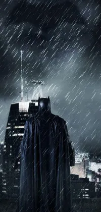 This live wallpaper for phones showcases an ominous yet captivating scene of a man wearing a Batman costume standing in the rain