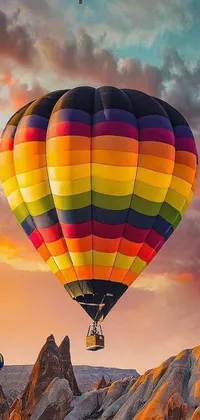 This stunning live wallpaper features a group of hot air balloons flying amidst a colorful sunset