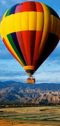 Add a splash of color to your phone screen with this dynamic live wallpaper featuring a colorful hot air balloon soaring over a lush field