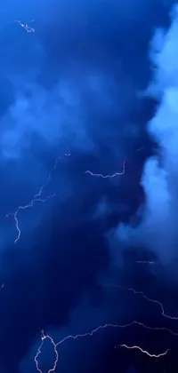This live wallpaper offers a stunning display of lightning strikes against a picturesque blue sky backdrop