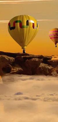 This live phone wallpaper features magnificent hot air balloons floating above scenic outdoor rocky terrains