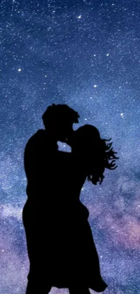 Looking for a stunning and romantic live wallpaper for your phone? Look no further than this beautiful design featuring a silhouette of a man and woman sharing a kiss under a star-filled night sky