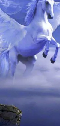 This live wallpaper showcases a stunning airbrush painting of a white-winged horse flying over a cliff against a clear blue sky