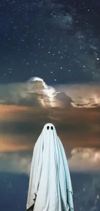 This fascinating live wallpaper showcases a mysterious figure wearing a ghost outfit and gazing towards the sky