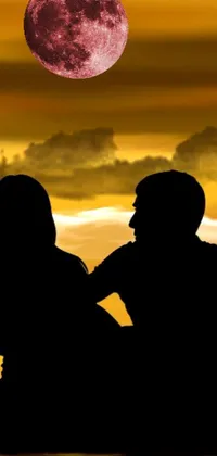 Enjoy a peaceful and romantic view on your phone screen with this live wallpaper of a couple sitting on a bench under a golden sunset sky gazing at the moon