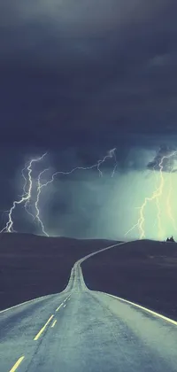 This live wallpaper showcases a long winding road enveloped in a menacing thunderstorm
