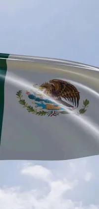 This phone live wallpaper features a stunning digital rendering of the Mexican flag flying high in the clear blue sky
