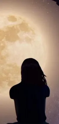 Looking for a captivating phone wallpaper? This trending live wallpaper features a mysterious woman sitting in front of a full moon set in the solar system