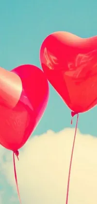 This live wallpaper features two red heart-shaped balloons that gently float in the sky, creating an enchanting atmosphere on your phone's background