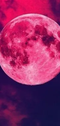 This live phone wallpaper features a mesmerizing pink full moon against clouds in the background