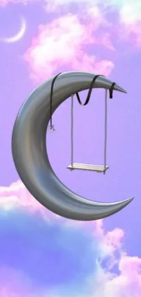 This live wallpaper for your phone features a swing hanging from a crescent moon