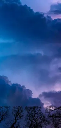 Looking for a stunning live wallpaper for your phone? Look no further than this clock tower-themed wallpaper, featuring a beautiful clock tower set against a stormy blue and violet sky