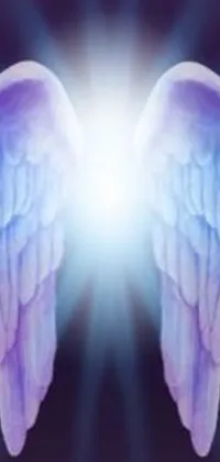 This mobile live wallpaper features a stunning pair of angelic wings in front of a radiant light on a deep indigo background