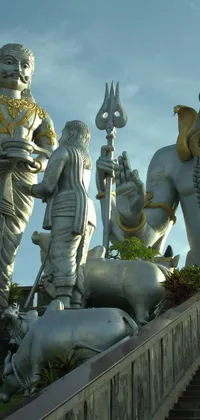 This live wallpaper showcases an impressive group of statues perched atop a grand staircase