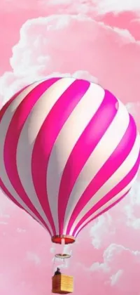 This lively phone live wallpaper showcases a charming hot air balloon floating gracefully through a bright blue sky