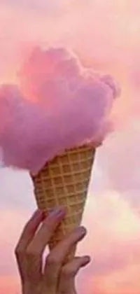 This phone live wallpaper depicts a hand holding an ice cream cone with three scoops of deliciously colorful ice cream