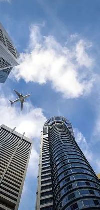 This phone live wallpaper features a breathtaking image of a plane soaring above a group of towering modern buildings in Singapore