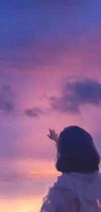 This live wallpaper showcases a captivating scene of a woman standing on a beach overlooking the ocean, with a tumblr and aesthetic vibe