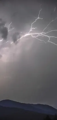 This live phone wallpaper showcases the raw power of nature as a lightning bolt bursts through cloudy skies