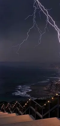 This phone live wallpaper depicts stairs near water with lightning, a thunderstorm, a thunder goddess, and Thor's hammer Mjölnir