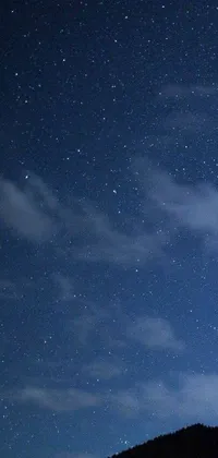 This live phone wallpaper features a night sky filled with stars, planets, and a moon