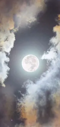 This stunning live wallpaper features a breathtakingly beautiful full moon shining brightly through the clouds