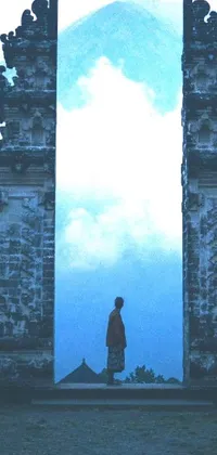 This breathtaking live phone wallpaper features a mystical scene of a person standing in front of a majestic stone gate in Bali