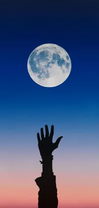 This captivating live phone wallpaper features a mysterious figure holding a shield and an axe, reaching towards a massive blue moon