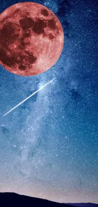 This live wallpaper for phones features a breathtaking scene under a full moon with a red planetoid exploding in the background