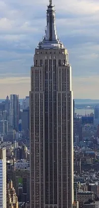 This unique live wallpaper design centers on a breathtaking, sky-high building standing tall over a busy cityscape