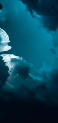 Get mesmerized by the phone live wallpaper featuring a gloomy sky filled with dark clouds sourced from Unsplash, providing a high-quality and eye-catching background