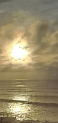 Enjoy the soothing beauty of a live winter sunset over the ocean on your phone with this highly realistic live wallpaper