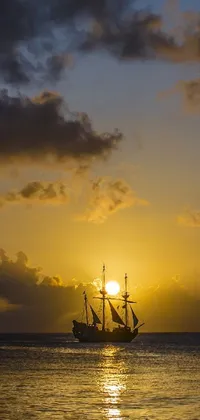 This phone live wallpaper features a serene sailboat in the tranquil ocean at sunset