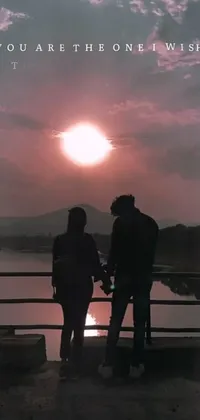 This live wallpaper depicts a romantic scene of a couple standing on a bridge in Guwahati